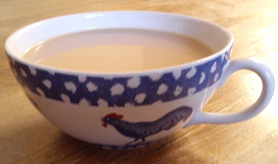 Tea in cup with blue chicken and snowy border