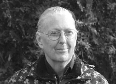 Older white woman wearing glasses and smiling