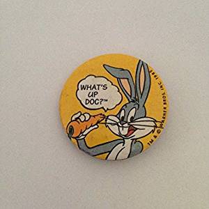 Vintage yellow Bugs Bunny badge saying 'What's Up, Doc?'