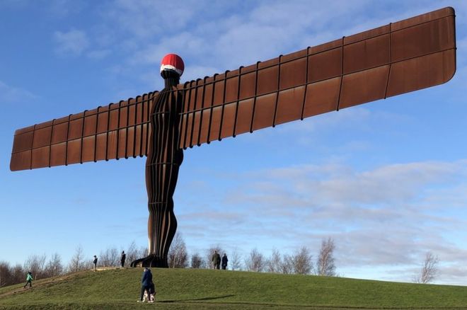 The Angel of the North with a Christmas hat on its head