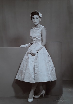 Black and white photo of Japanese woman in 1950s western dress