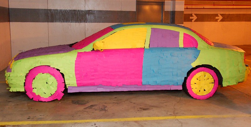 Colour photograph of a Jaguar covered with post-it notes