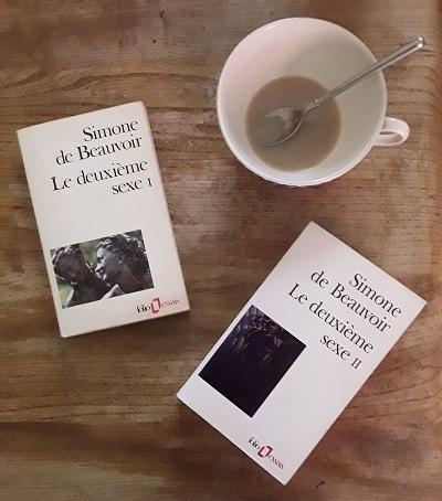 Cup of tea with copies of de Beauvoir's two volume Le Deuxieme Sexe beside it.