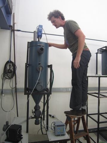 Man inspecting a high capacity community-scale struvite reactor.