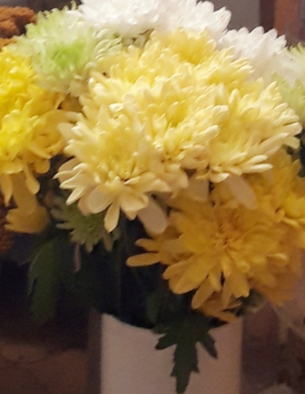 Yellow flowers in white vase