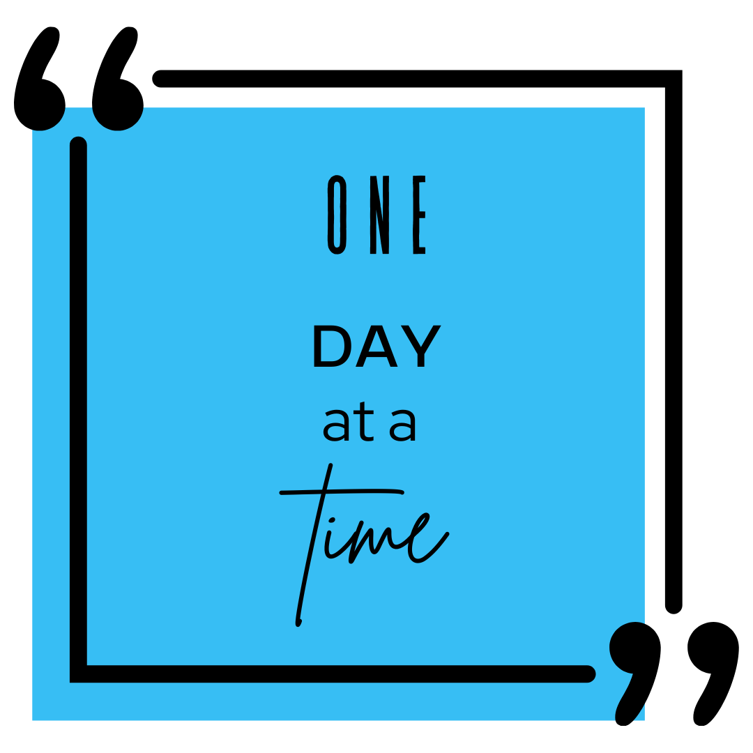A sqaure box with one day at a time written in it