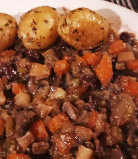 Casserole containing Aubergine, carrots, beans and mushrooms.