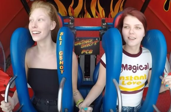 two young women on slingshot ride calm, before launch