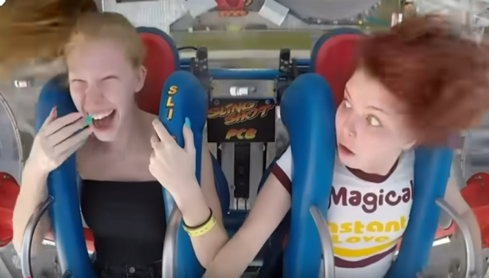 two girls on faiground ride one worried