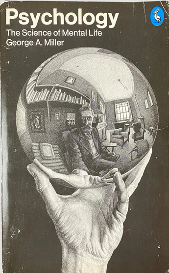 Image of a book on psychology. A drawing is of a hand holding a reflective ball
