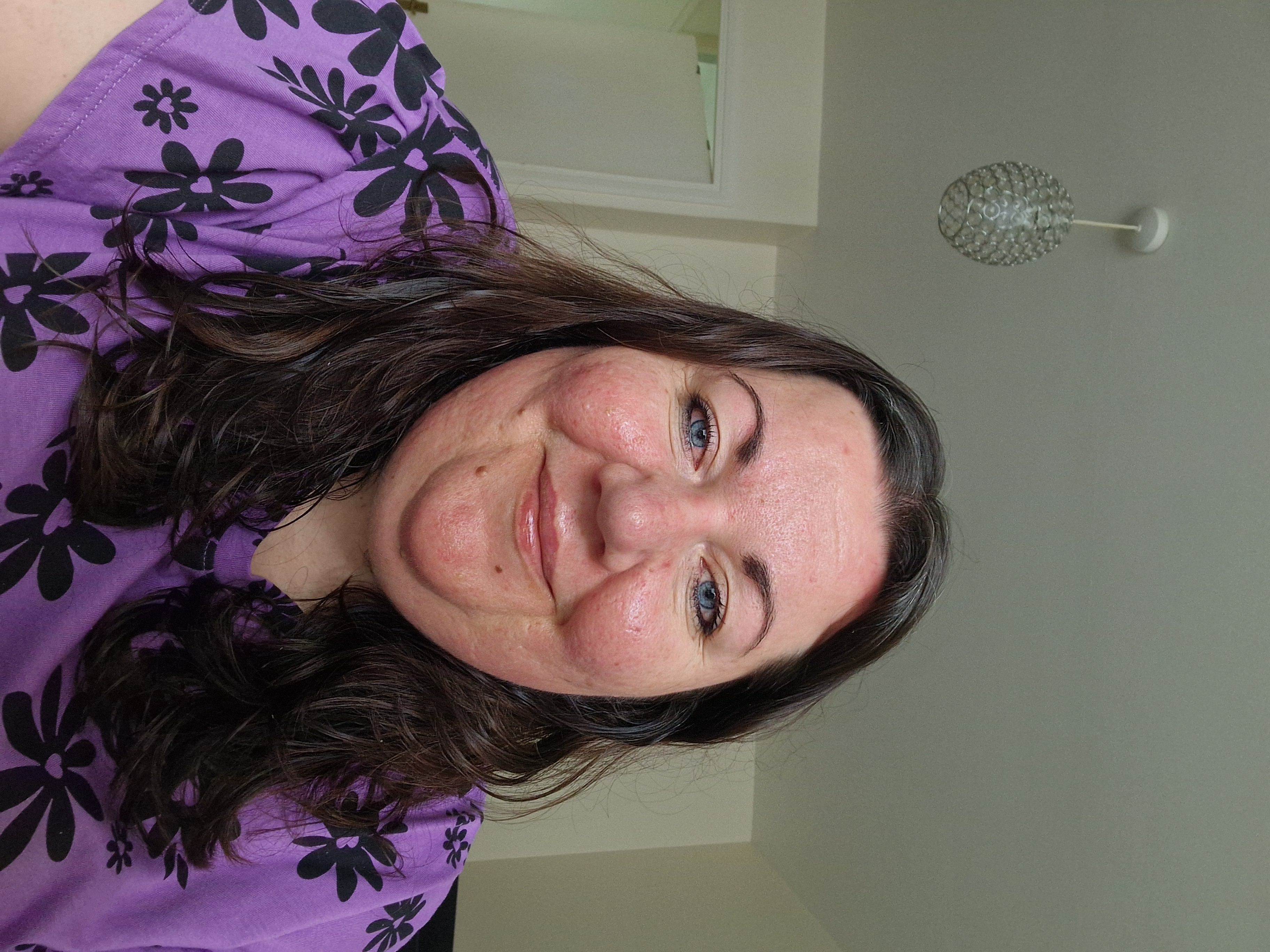 Image of a student rep wearing a purple dress with black flowers.