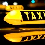 Lit yellow-and-black taxi sign
