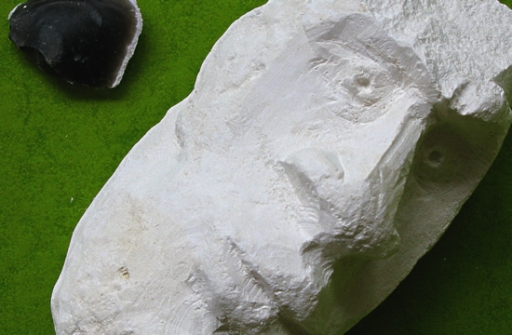 Carved chalk head with flint shard tool